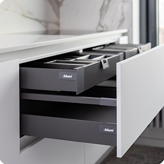 Modern drawer box system with sleek, matte black finish and organized compartments, designed for efficient storage and easy access in a minimalist kitchen setting.